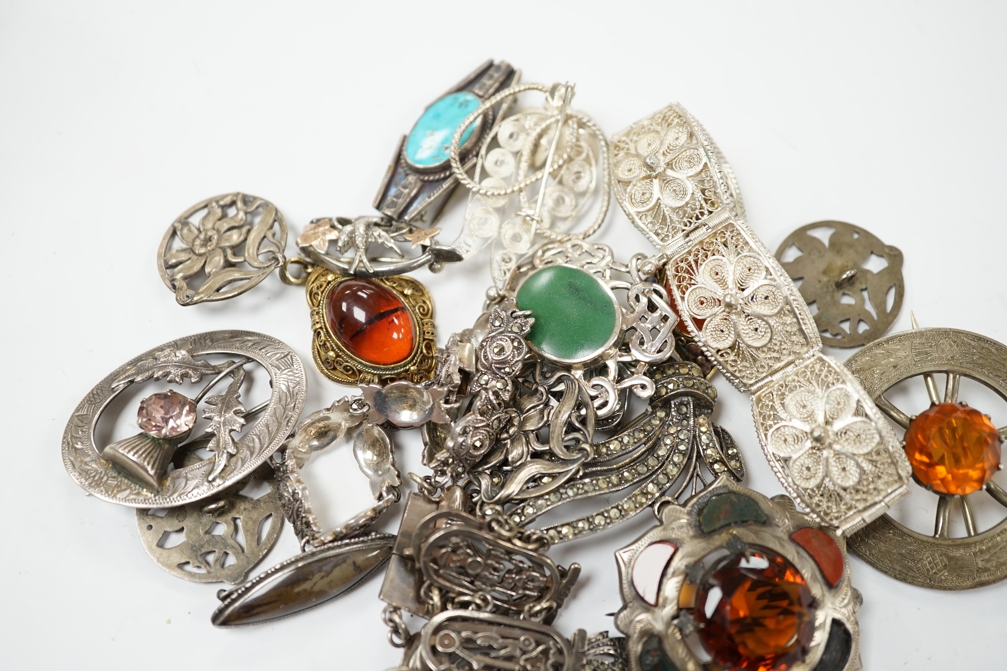 A small quantity of assorted silver and white metal jewellery including filigree bracelet, Scottish hardstone and gem set brooches, etc. Condition - poor to fair
